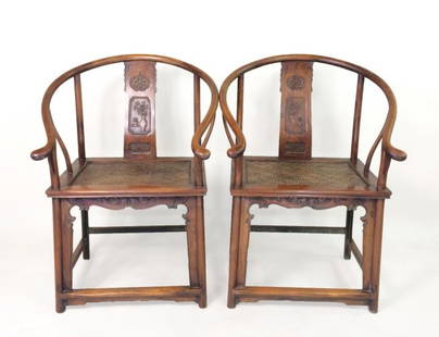 A PAIR OF HUANGHUALI HORSESHOE BACK WOVEN ARM CHAIRS: A PAIR OF CHINESE HUANGHUALI HORSESHOE BACK ARM CHAIRS, QUANYI, with WOVEN RATTAN SEAT. With sweeping crest rail terminating in out swept hooks above shaped spandrels, all above the curved splat carv