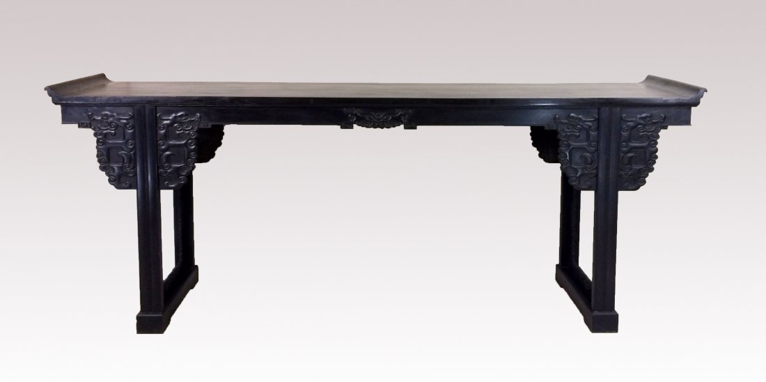 LARGE CARVED ZITAN ALTAR TABLE: LARGE CARVED ZITAN ALTAR TABLE, The thick single-plank top with beaded edge and set with everted ends, the underside with narrow raised border, beaded single-panel aprons carved with integral archaic