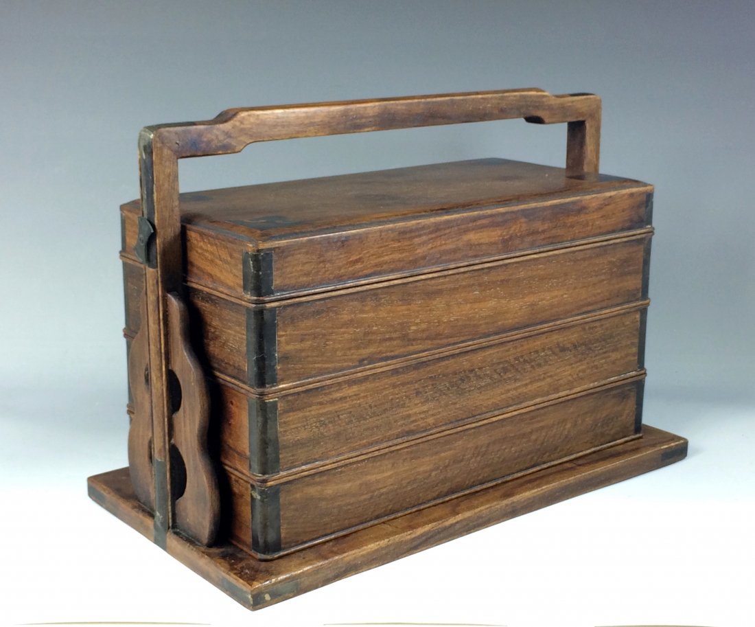 A THREE TIERS HUANGHUALI PICNIC BOX W/ INLAID BRASS: Chinese HuangHuaLi Three Tiers Lunch Box. China, the Rectangular smooth and dense HuangHuaLi wood, smooth grained containers composed of a cover pierced for the flat securing brass stick, reversing to