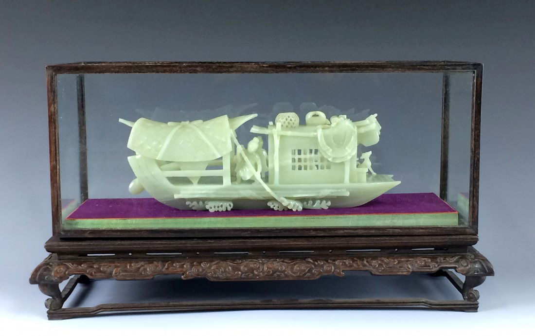 A FINE ANTIQUE GLASS FRAMED WHITE JADE OF BOAT: A Fine Antique Carved Chinese White Jade of Boat inside a Glass Framed Display Show Case. The Jade Stone expertly carved open work resembled a traditional boat, showing two figures onboard, with group