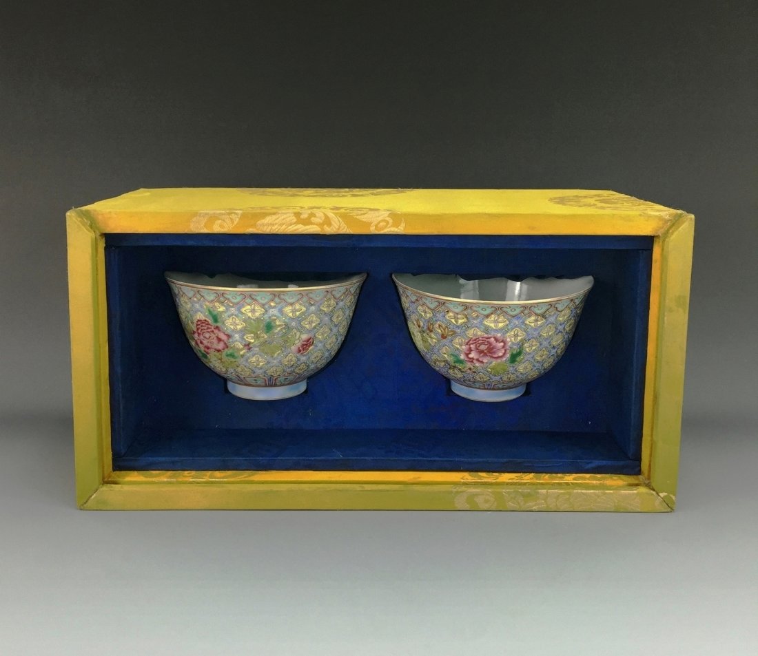 IMPORTANT PAIR OF FAMILLE ROSE WINE CUPS IN ORIGINAL: A FINE and Important Pair of Qing Dynasty Chinese Famille Rose Wine Cups in Original Wooden Silk Box. The rounded body of the cups with slightly flared rim, raised on recessed foot ring, The exterior 