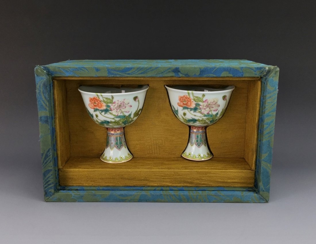 IMPORTANT PAIR OF FAMILLE ROSE HIGH WINE CUPS IN BOX: A FINE and Important Pair of Qing Dinasty Chinese Famille Rose High Wine Cups in Original Wooden Silk Box. The rounded body of the vase is finely potted with a broad base and a rounded shoulder under 