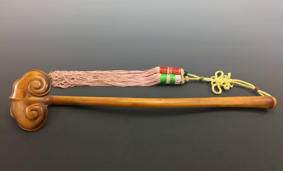 CARVED HUANGYANGMU RUYI SCPETERS: Finely carved HuangYangMu Ruyi Scepters, of LingZhi mushroom head with smooth handle. Having pink tassel emerged from yellow knotted ribbon. Dimension: 12-1/8" L The Sale Will Benefit IFGF