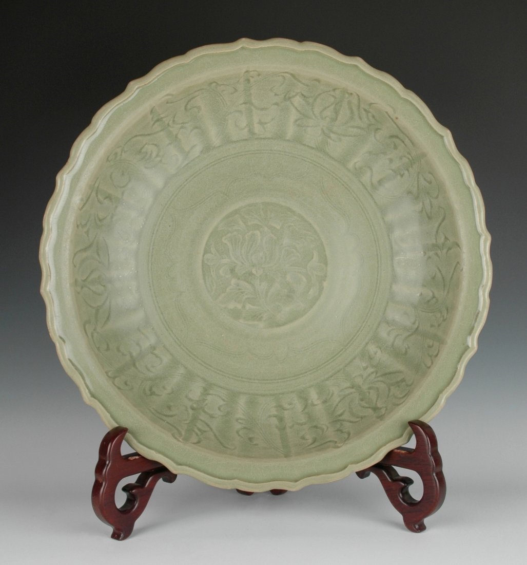 A FINE CARVED PEONY LONGQUAN CELADON BARBED-RIM CHARGER (1 of 9)