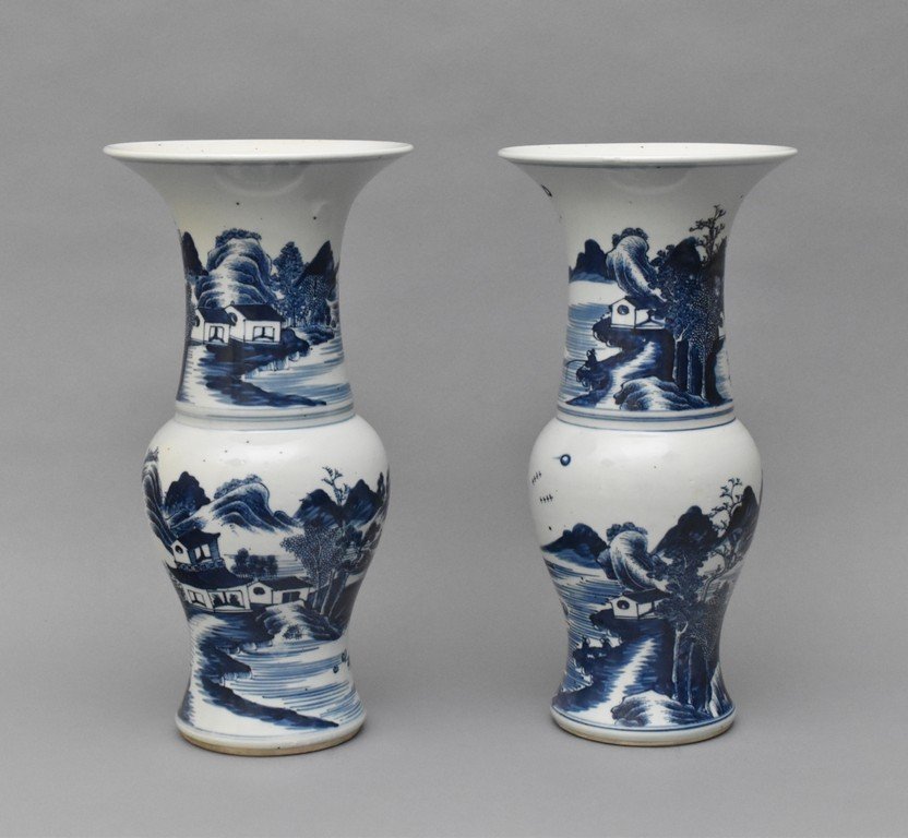 PAIR OF BLUE AND WHITE PHOENIX TAIL VASES: Both beakers having baluster shaped body, with bulging belly, trumpet-shaped neck are painted in tones of rich underglaze blue with scenes of humble village within waterside and misty mountainous land