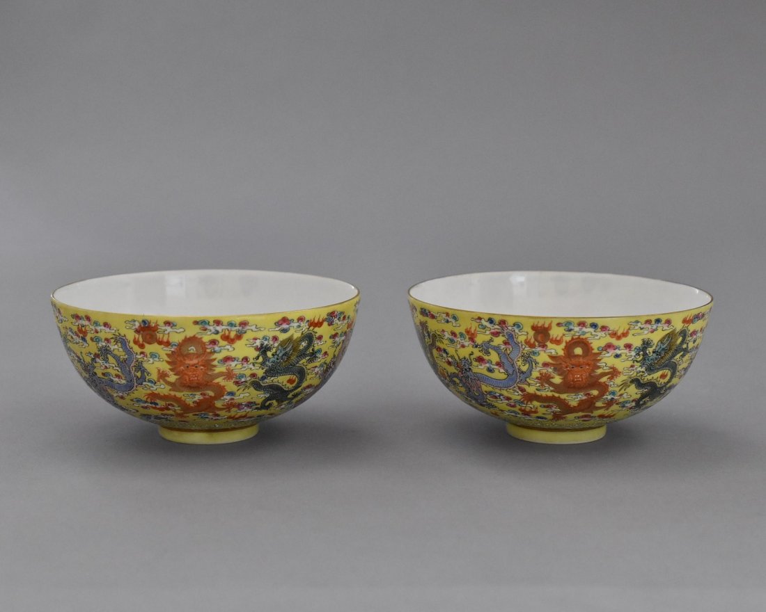 PAIR OF DRAGONS FAMILLE JAUNE PORCELAIN BOWLS: Having simply deep bowl, rounded cavetto to flat opening, upon narrow concave footed base. The exterior wealthy decorated with famille rose hand painting of colorful dragons within ruyi clouds and fla