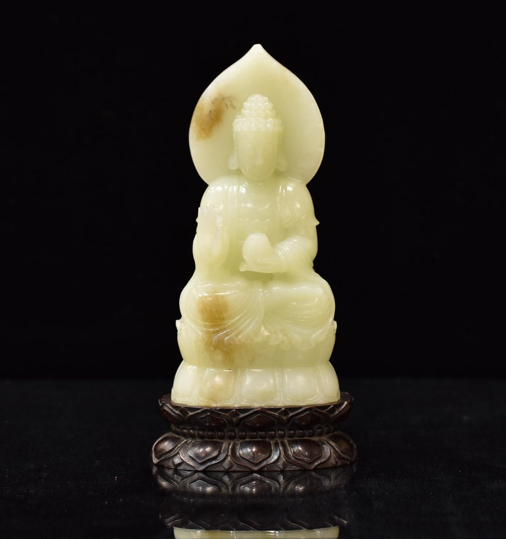 A CARVED CHINESE WHITE JADE BUDDHA ON STAND (1 of 8)