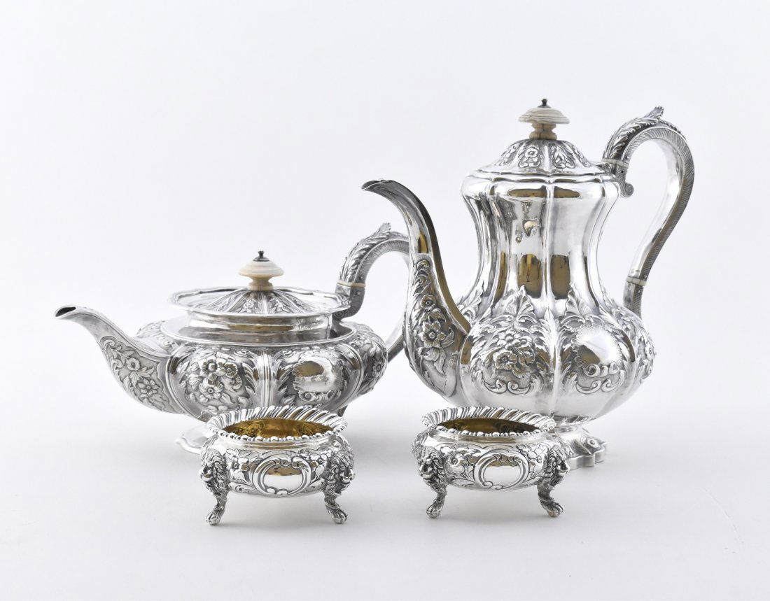 SET OF 4 SILVER TEA SET: Comprising a teapot, a coffee pot, with ivory insulators, an open sugar and creamer, each decorated with rococo flowering branches. Mark on base, incised maker's hallmarks, WRS, with further 4 marks.