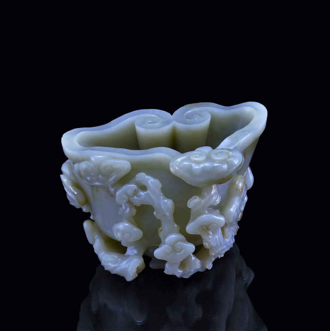 A LINGZHI FORM JADE BRUSH WASHER: The deep hollowed vessel in the form on a large LingZhi head borne on a gnarled stems and surrounded by smaller LingZhi fungus, with elaborate open carving of group of branching LingZhi mushroom resem