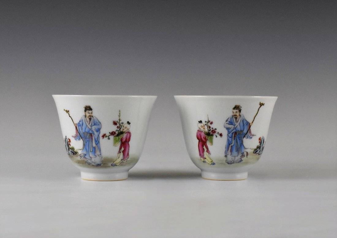 PAIR OF FAMILLE ROSE PORCELAIN WINE CUPS, XIANFENG MARK: The pair of Chinese porcelain wine cups having deep bowl body, steep sides raised on rounded cavetto toward slightly flared rim, upon concaved foot base. The exterior decorated with famille rose hand