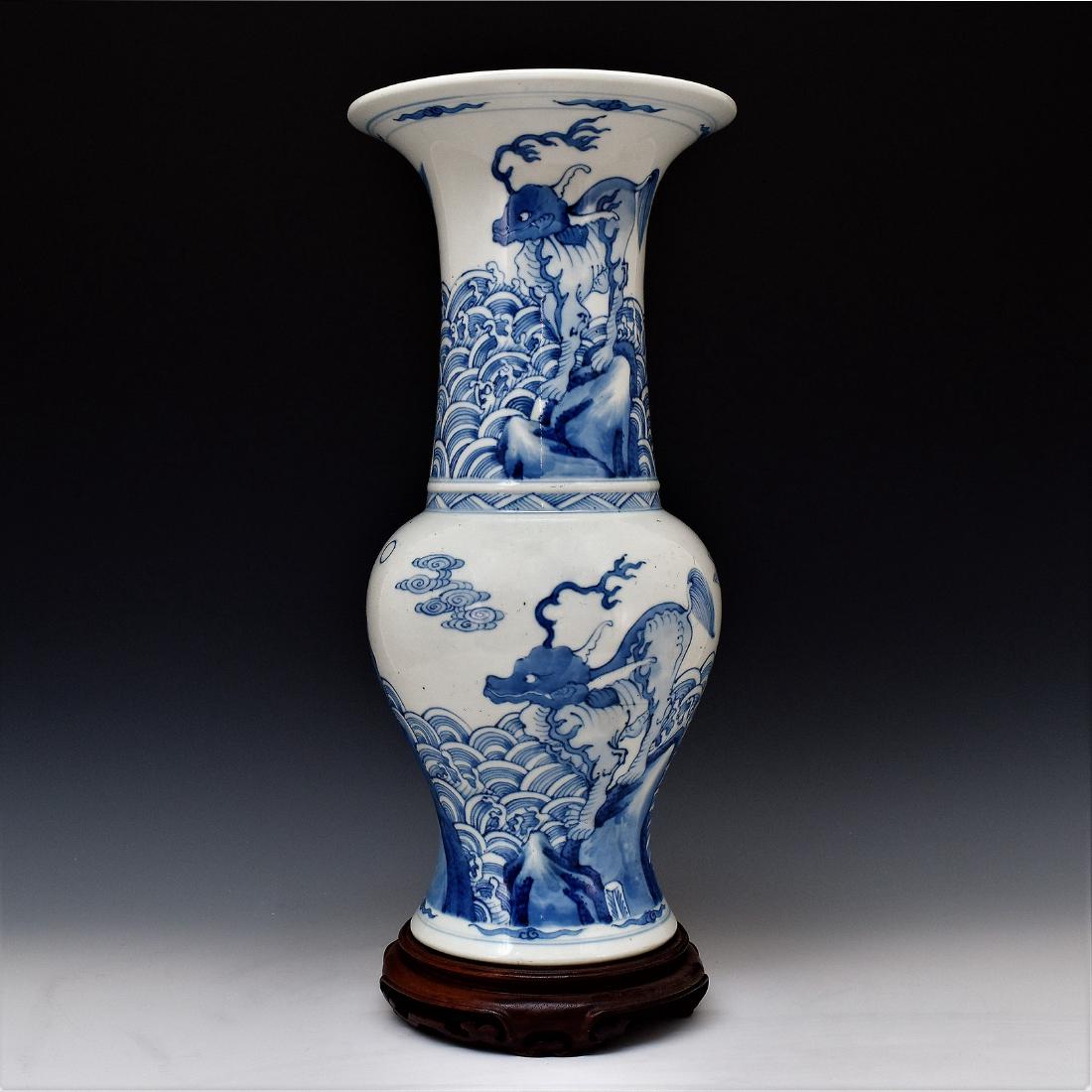 BLUE & WHITE QILING GU VASE ON STAND: The Chinese porcelain beaker vase potted in Chinese traditional Gu form. The beaker having baluster shaped body, with bulging belly, trumpet-shaped neck are painted in tones of rich underglaze cobalt-
