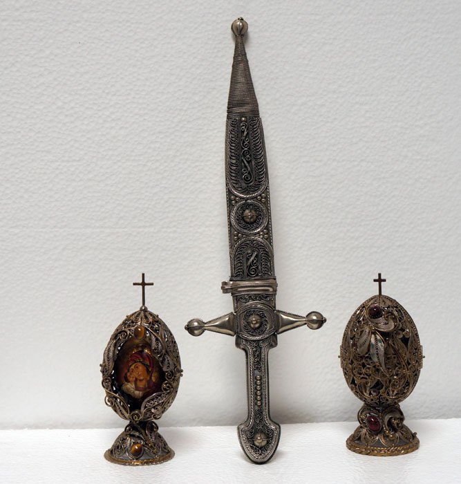 METAL FILIGREE WORK, Russian (?) c. late 20th C.: Title: Two wooden, painted eggs in cases that open up (see photos), plus ceremonial knife, with stainless blade(), each item with elaborate metal filigree,and the knife with additional elaborate incis