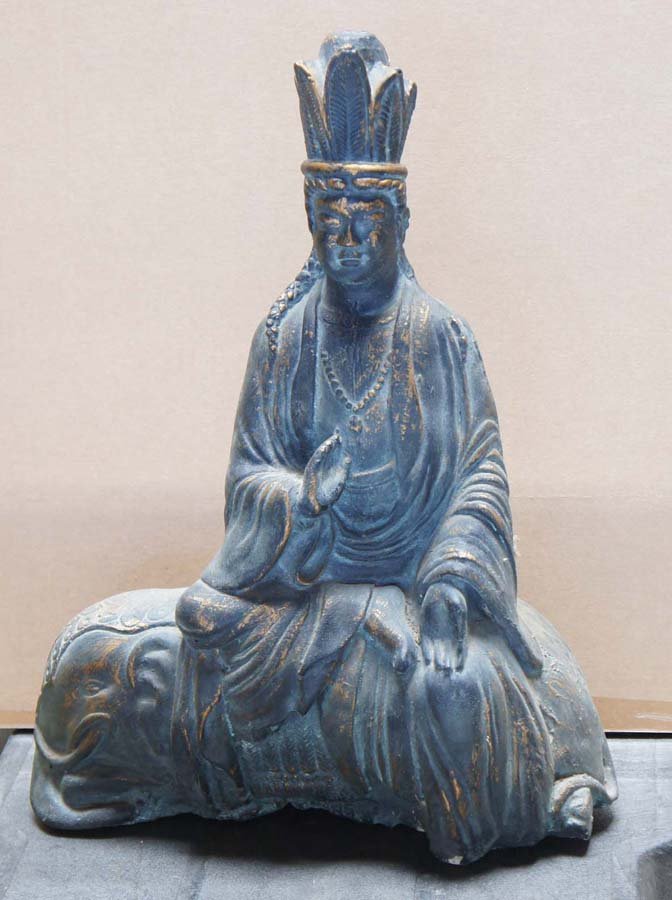 Asian Style Doorstop: Doorstop using Asian or possibly Mezo-American religious figure, mold made, concrete or similar material with gold paint underneath patina, c. 1950-1980, , , rnrn rn•Size: 20 by 17 by 9 in. (50 x 32