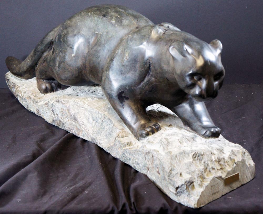 (Canadian Inuit?), 20th Century,: Title: "Cougar", soapstone sculpture on granite base, c, 1975, , , , , Size info: 28 x 12 x 9 inches, , , Framing: , , Comments: Has a metal plate t