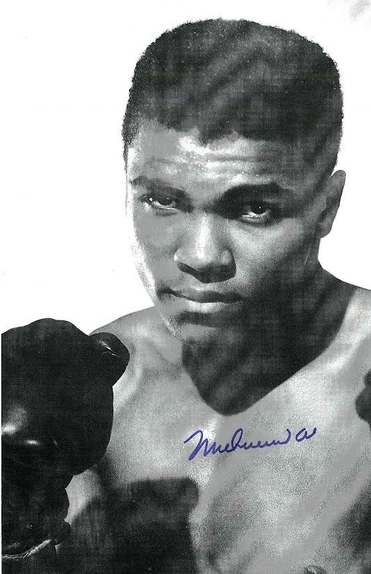 Muhammad Ali Signed Photograph AAU: Muhammad Ali Signed Photograph AAU F12415 black and white photograph holding up his gloves. 8x9 inches