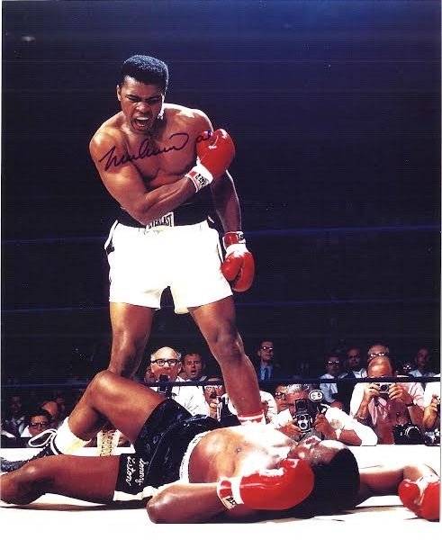 Muhammad Ali Signed Photograph AAU: Muhammad Ali Signed Photograph AAU F12403 Color photograph of Ali standing over Liston 8 x 9.5 inches.