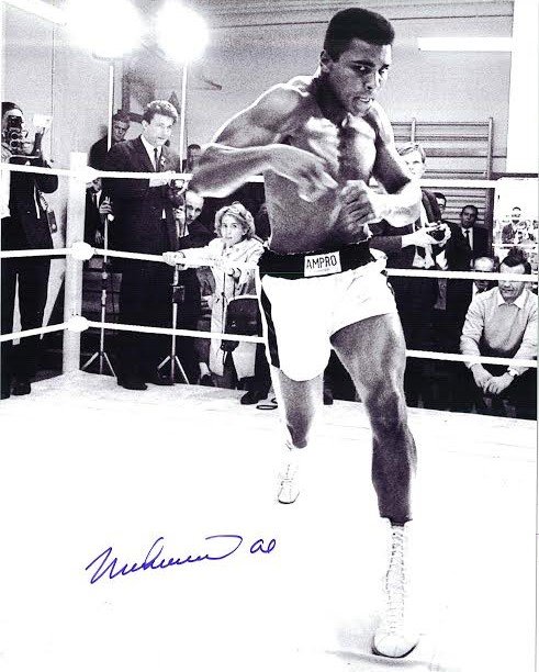 Muhammad Ali Signed Photograph AAU: Muhammad Ali Signed Photograph AAU F12413 this is a black and white photograph of Ali shadowboxing which measures 8 x 10 inches.