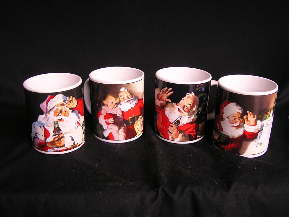 Santa Claus Mugs Coca Cola: This is a beautiful set of 4 Santa Coca Cola mugs by Sakura. They are 4" tall x 3 1/4" round. They were issued in 2002 and are in unused condition. Valued at $25 - $35.