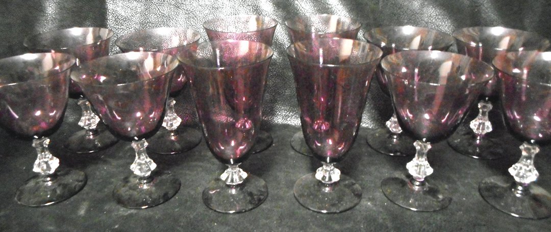 12 Purple Crystal Glasses: These are very nice glasses and the stem is decorated with a large crystal detail. There are 8 cocktail and 4 water glasses.The sizes of these glasses are 6 inchs and 6 1/2 inches.