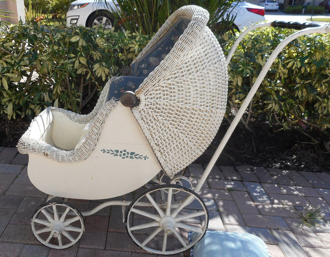 Woven Wicker Antique Baby Carriage: This is an old woven wicker, iron and wood baby carriage. I don't know how old but if cleaned up a little would be a great carriage for a doll collector.
