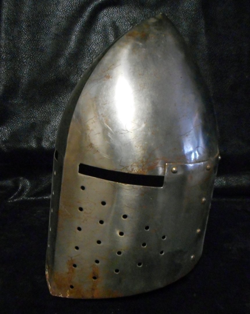Metal Helmet in the style of the Middle Ages: This is not an old helmet but rather a reproduction of an old helmet. It is very well done and riveted and is made of a hard metal. The helmet is life size.WIN 5 ITEMS IN THIS AUCTION AND YOU CAN CHOO