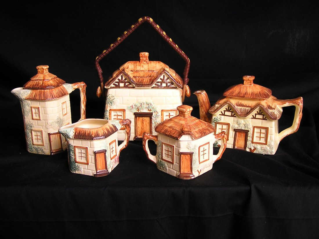 Keele St Pottery Earthenware from England. Teapot etc.: Quaint set of 1940's Earthenware from England depicting cottages. Set includes a Cookie Jar, Teapot, Coffee Pot, Sugar and Creamer.