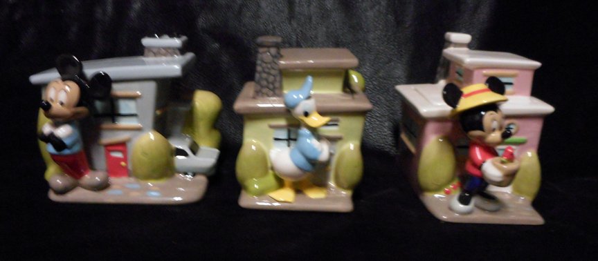 3 Disney Canisters or Conatiners: Mickey, Minnie, Daisy: 3 Canisters of Mickey, Minnie and Daisy in front of their homes.Roofs of houses lift off. They are about 8 inches high.
