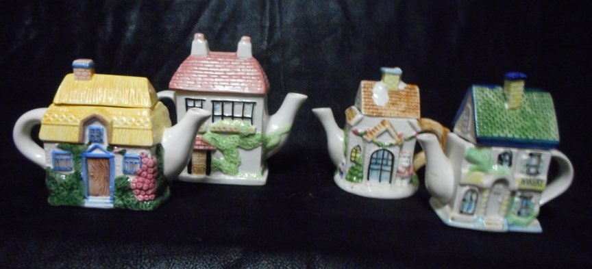 7 Teapots: Cottages, Houses and Amish Teapot and S&C: 7 Teapots of various cottages and houses plus an Amish Teapot with a Sugar and Creamer