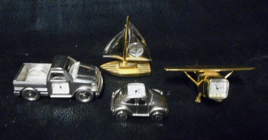 4 Timex Figurative Clocks: Plane, Boat, Car, Truck: These are 4 Timex Metal Figurative Clocks. They are very well made and depict a Plane, Sailboat, Truck and a Volkswagon Car. These are small time pieces, 1 12 inch to 2 inches each. Each of these item