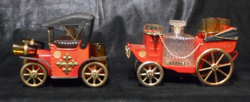 Liquor Decanter Antique Cars: These are two liquor decanters complete with shot glasses in the shape of two antique cars. Each car is complete with a liquor bottle and shot glasses.