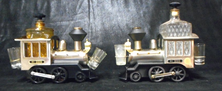 2 Antique Liquor Bottle Locomotive Decanters Music Box: Two Locomotive Decanters which play music complete with shot glasses. Old but I don't know how old.