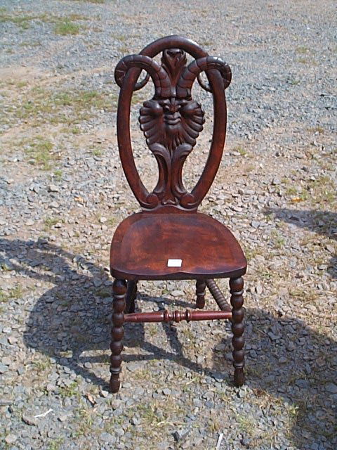 173: Carved walnut side chair depicting North Wind face: Carved walnut side chair depicting North Wind face with ram antlers. Measures 41" tall by 16.5" long by 16.5" wide with a seat height of 18" tall. Local delivery available within a 60 mile radius of S