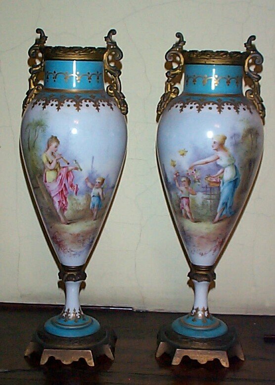 Pair of Sevres 12 in. urns with bronze mounts