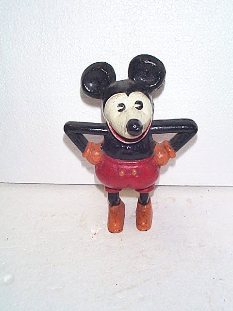 Cast iron Mickey Mouse bank. We are not sure if: Cast iron Mickey Mouse bank. We are not sure if this is an antique or a reproduction. Does appear to have an antique paint job. However, buyer beware. Measures 8" tall. Buyer to pay $25.00 shipping an