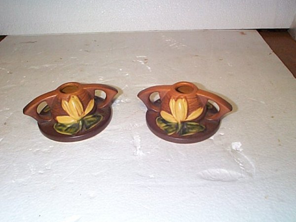 Pair of Roseville waterlilly single candlesticks,