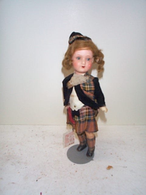 German painted bisque head doll in a Scottish moti