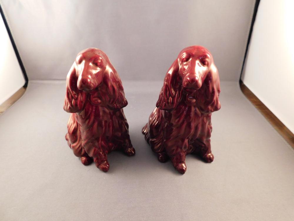 Pair of Zsolnay Art Pottery Dogs: Zsolnay Hungarian pair of iridescent red art pottery dogs. Measures approx. 4 3/4" tall. You are bidding at a live sale. Please Read the terms and conditions. We are offering scheduled pick-ups of ite