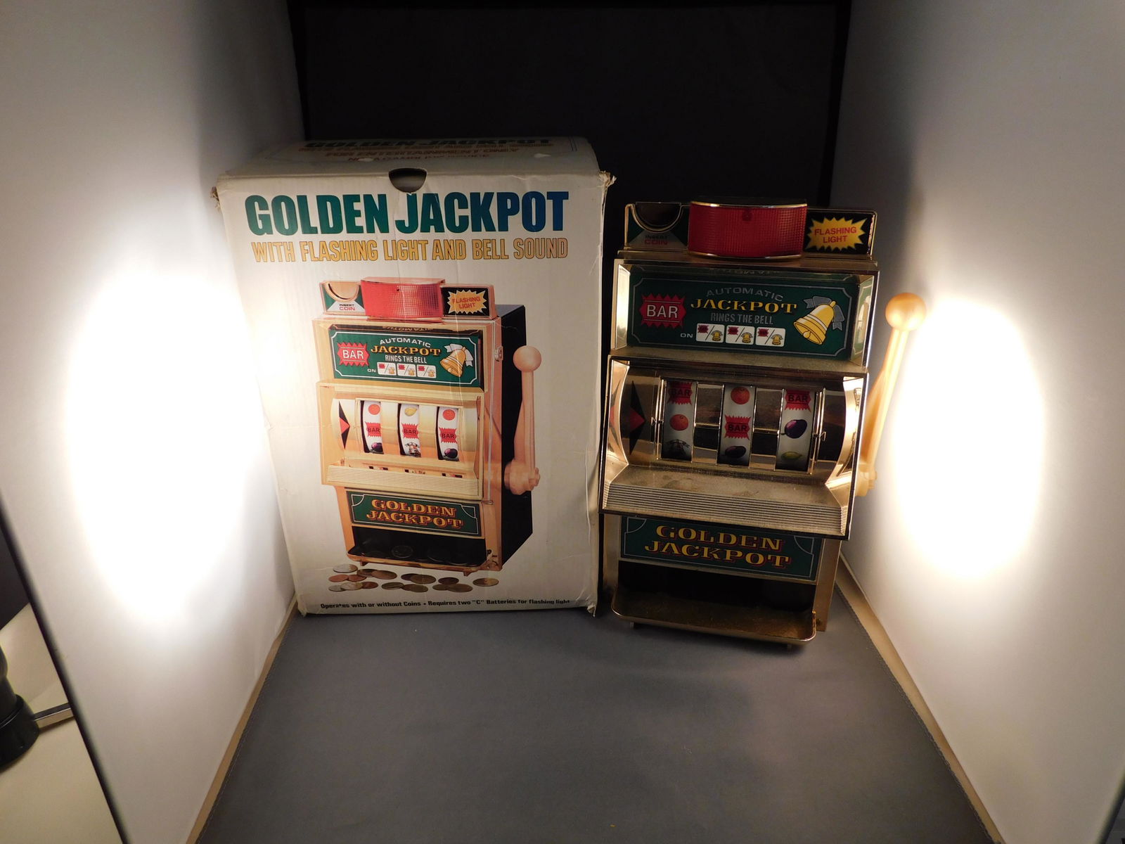 Golden Jackpot Slot Machine: Japanese Golden Jackpot slot machine with flashing light and bell in original box. Measures approx. 11" tall. You are bidding at a live sale. Please Read the terms and conditions. We are offering sche