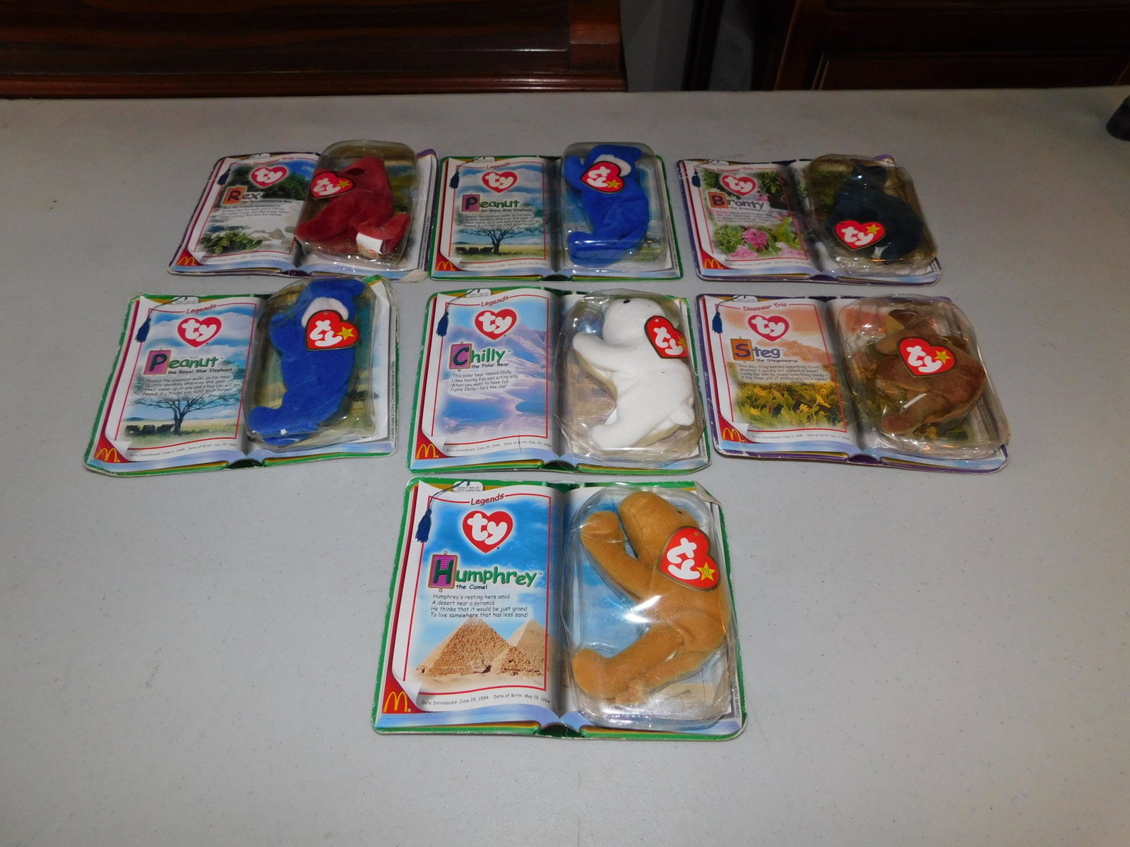 7 McDonalds Beanie Babies.: Lot of 7 McDonalds Beanie Babies including Humphrey, 2 Peanut, Chilly, Steg, Rex and Bronty. All in good condition. You are bidding at a live sale. Please Read the terms and conditions. We are offerin