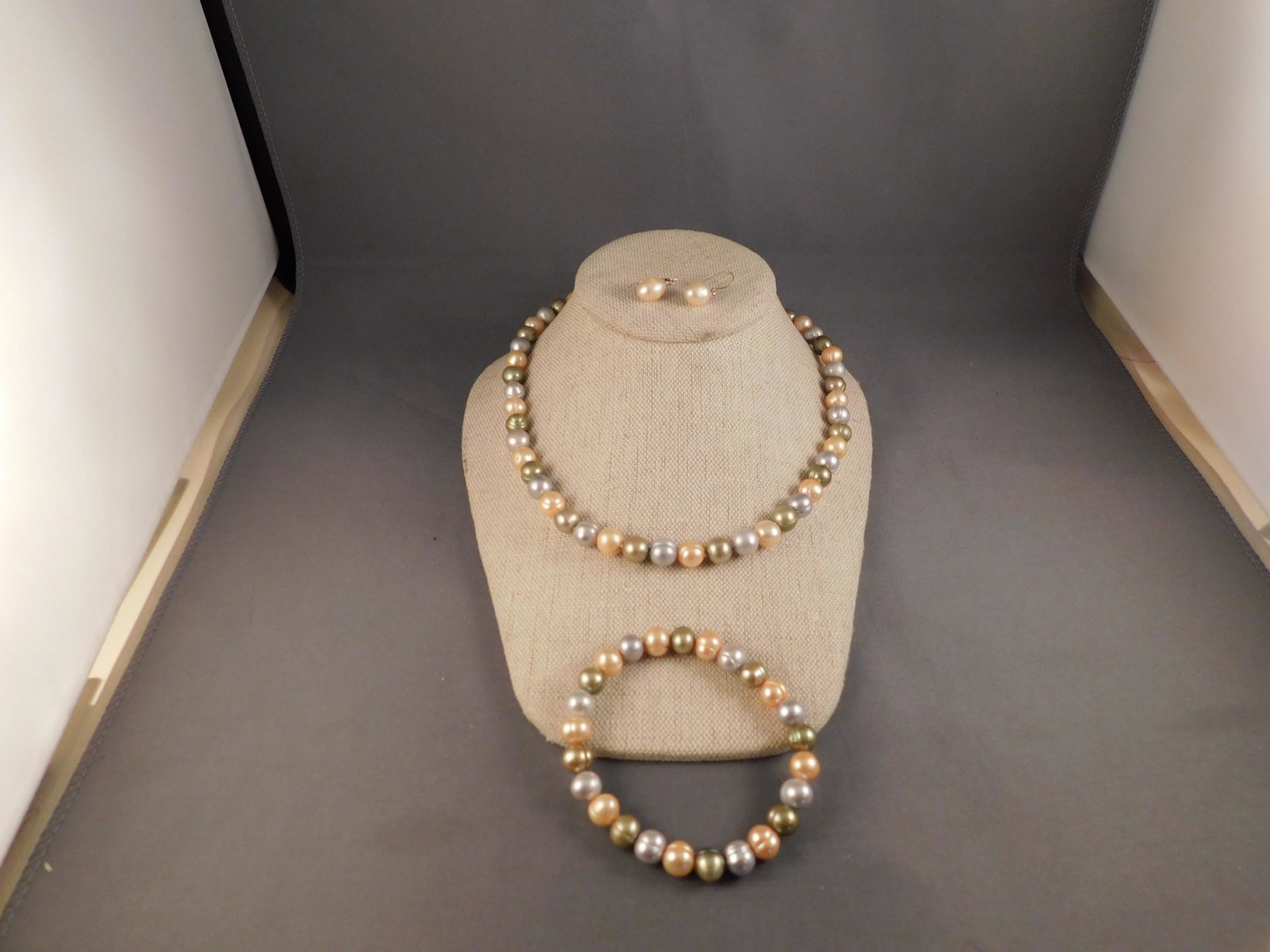 Multicolored Pearl Necklace/Bracelet and Earrings: Strand of multi colored pearls with a matching bracelet and sterling and pearl earrings. The necklace measures approx. 16", the bracelet 7", and the earrings 1 1/4". You are bidding at a live sale. Pl