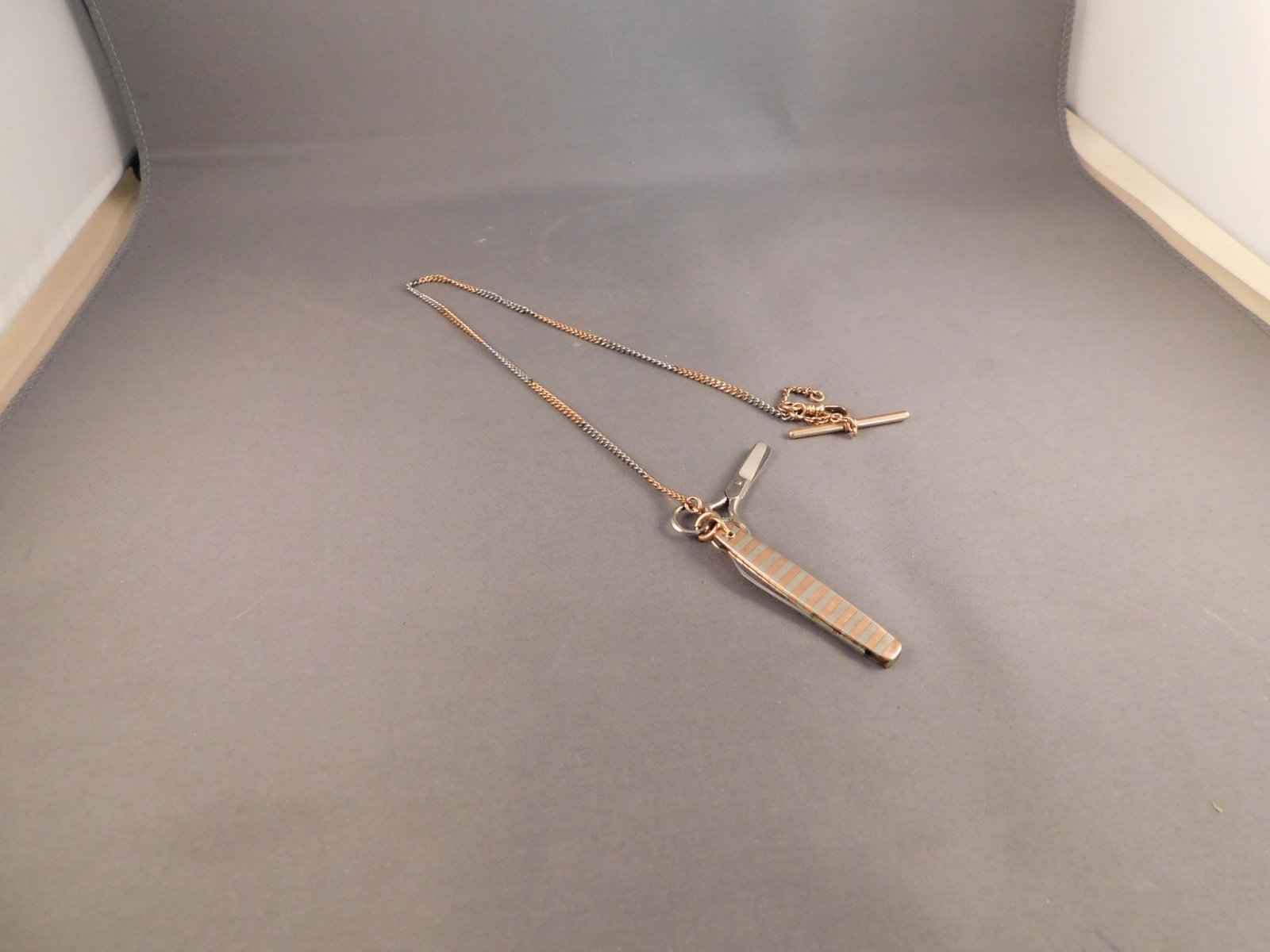 Edwardian Era Fob: Edwardian era ladies sewing fob. With a miniature scissor and blade at the bottom. Measures approx. 15" long. You are bidding at a live sale. Please read the terms and conditions. We are offering appo