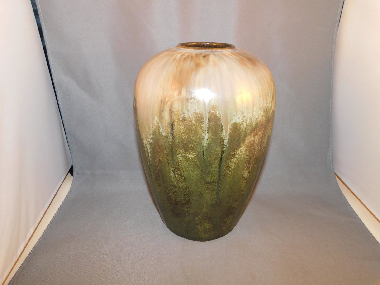 Prang Art Pottery Vase: Fulper marked Prang art pottery vase in a green/cream finish with luster at the top and a matt finish at the bottom. Measures approx. 8" tall x 5" wide. You are bidding at a live sale. Please read the