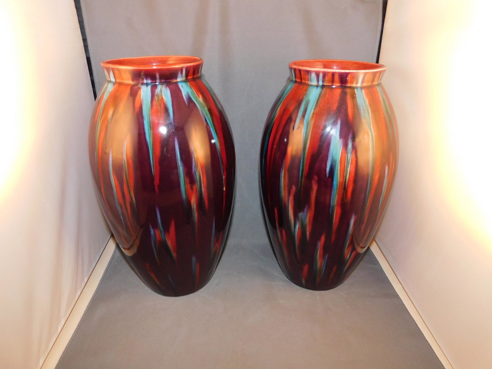 Pair of Sarreguemines Ovoid Vases: Pair of Sarreguemines ovoid vases, one with marks on the bottom. Done in blue/red and black glaze. Measures approx. 11" tall x 8" wide. You are bidding at a live sale. Please read the terms and condit