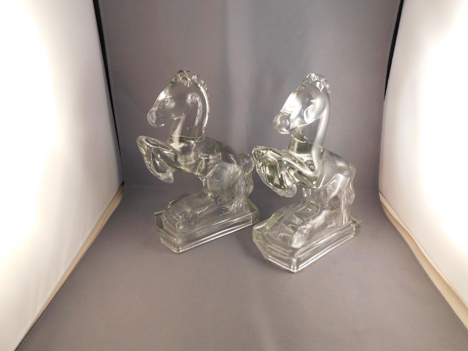Pair of Cambridge Glass Horses: Pair of Cambridge glass house figurines. Measures approx. 8" tall x 5 1/2" wide. You are bidding at a live sale. Please read the terms and conditions. We are offering no contact pick up at our South B