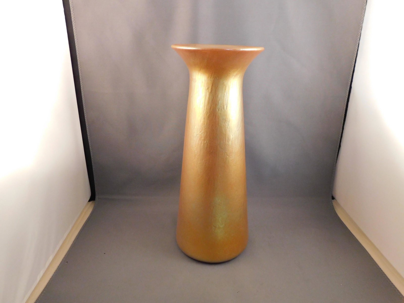 Lundberg Art Glass Vase: Art glass tall vase, artist signed Lundberg Studios, 5-22-98, J18, in a Tiffany type gold. Measures approx. 10" tall x 4" wide. You are bidding at a live sale. Please read the terms and conditions. We
