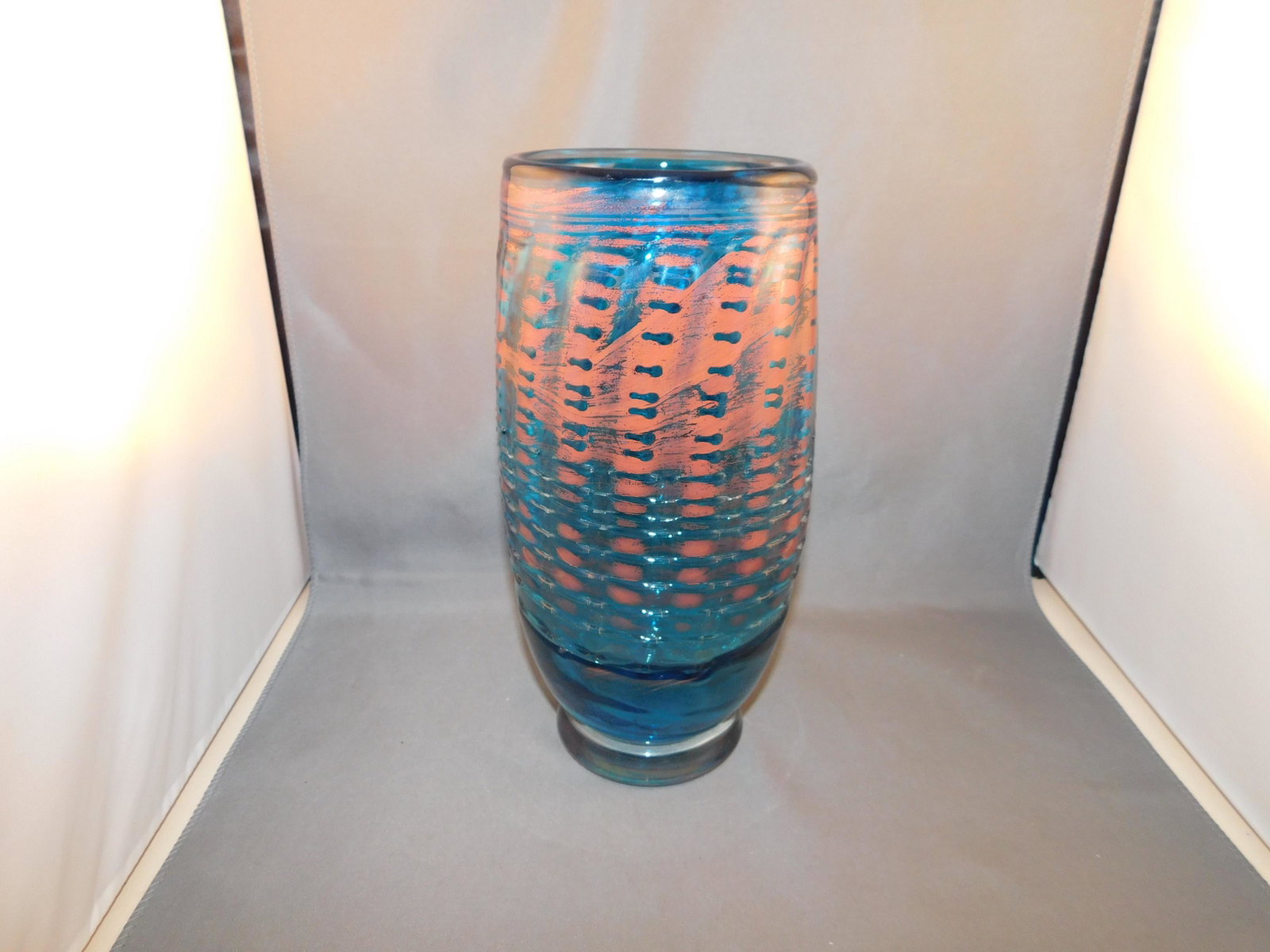 Art Glass Vase: Art glass tall vase . Is signed but illegible. Measures approx. 9" tall x 4 1/2" wide. You are bidding at a live sale. Please read the terms and conditions. We are offering no contact pick up at our S