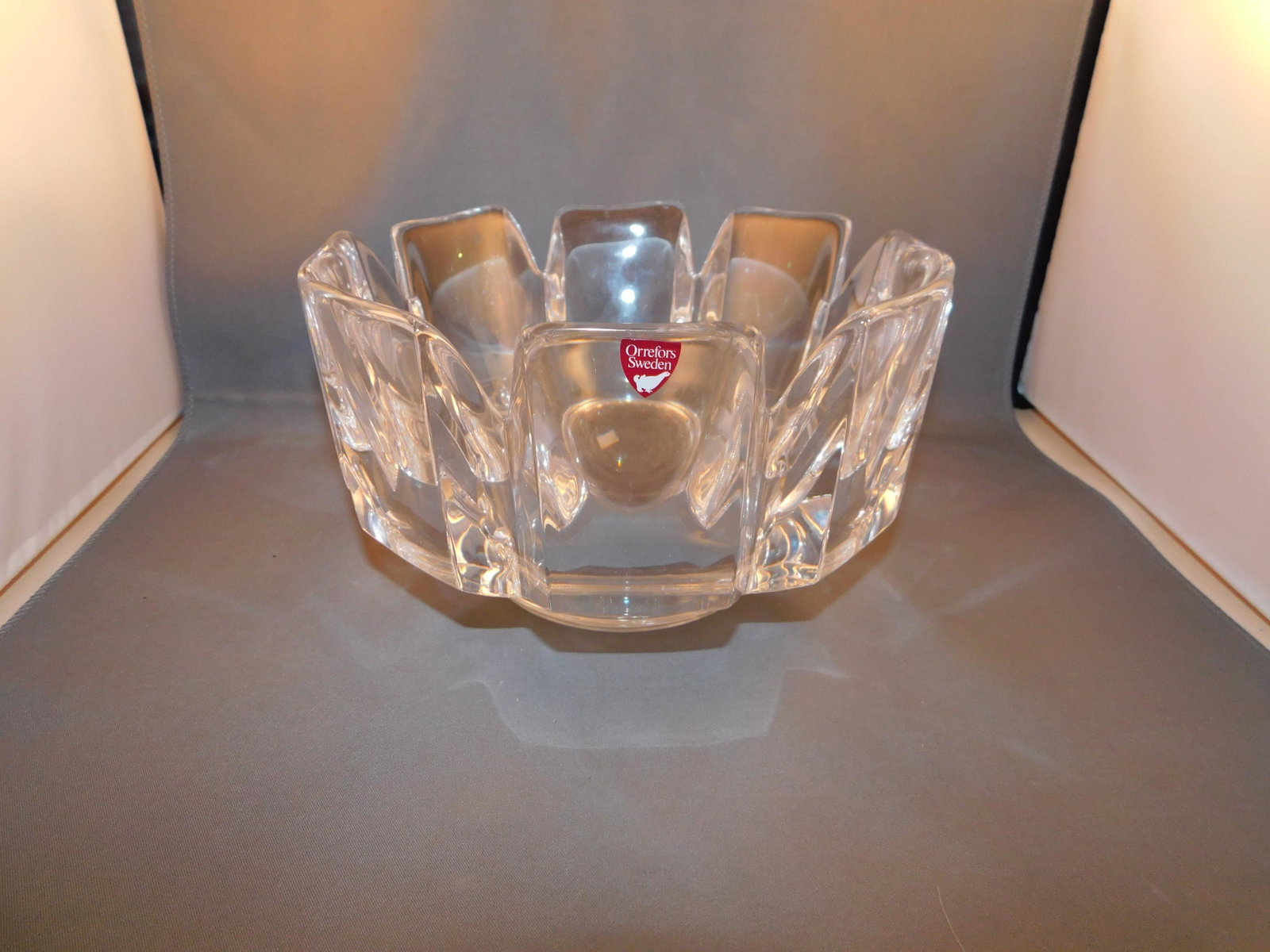 Orrefors Crystal Bowl: Orrefors crystal bowl. Marked Orrefors on the bottom and with paper label. Also marked LH 4384.131. Measures approx. 4" tall x 7 1/4" wide. You are bidding at a live sale. Please read the terms and co