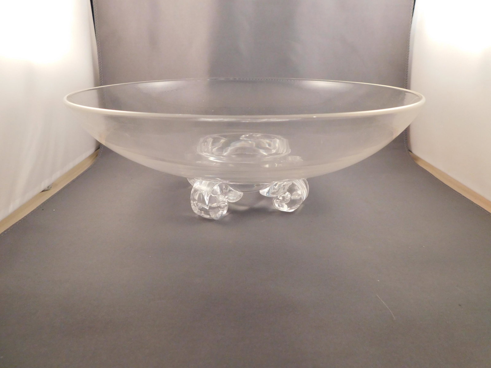 Stuben Art Glass Bowl: Art glass bowl signed Stuben. Has 4 feet on the bottom. Measures approx. 4" tall x 10 3/4" wide. You are bidding at a live sale. Please read the terms and conditions. We are offering no contact pick u