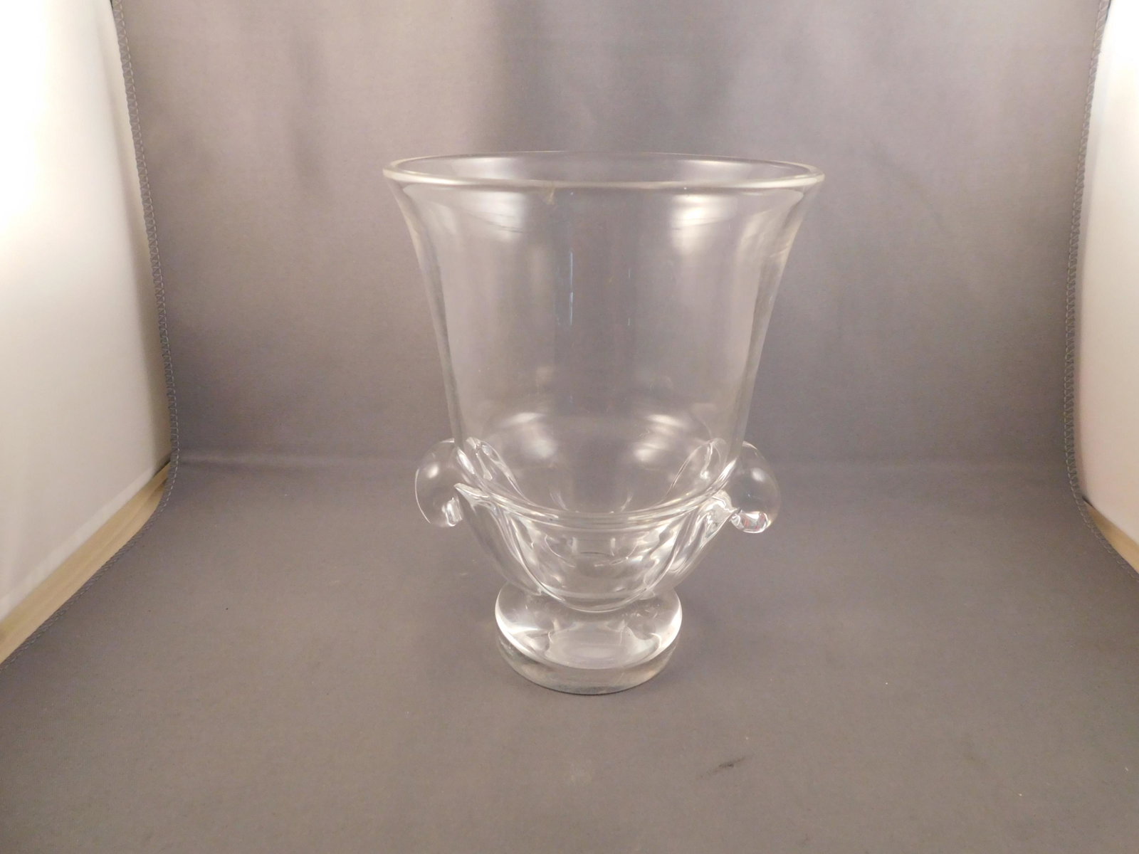Stuben Art Glass Urn/Vase: Art glass double handled urn/vase, signed Stuben. Measures approx. 6" tall x 4 1/2" wide. You are bidding at a live sale. Please read the terms and conditions. We are offering no contact pick up at ou