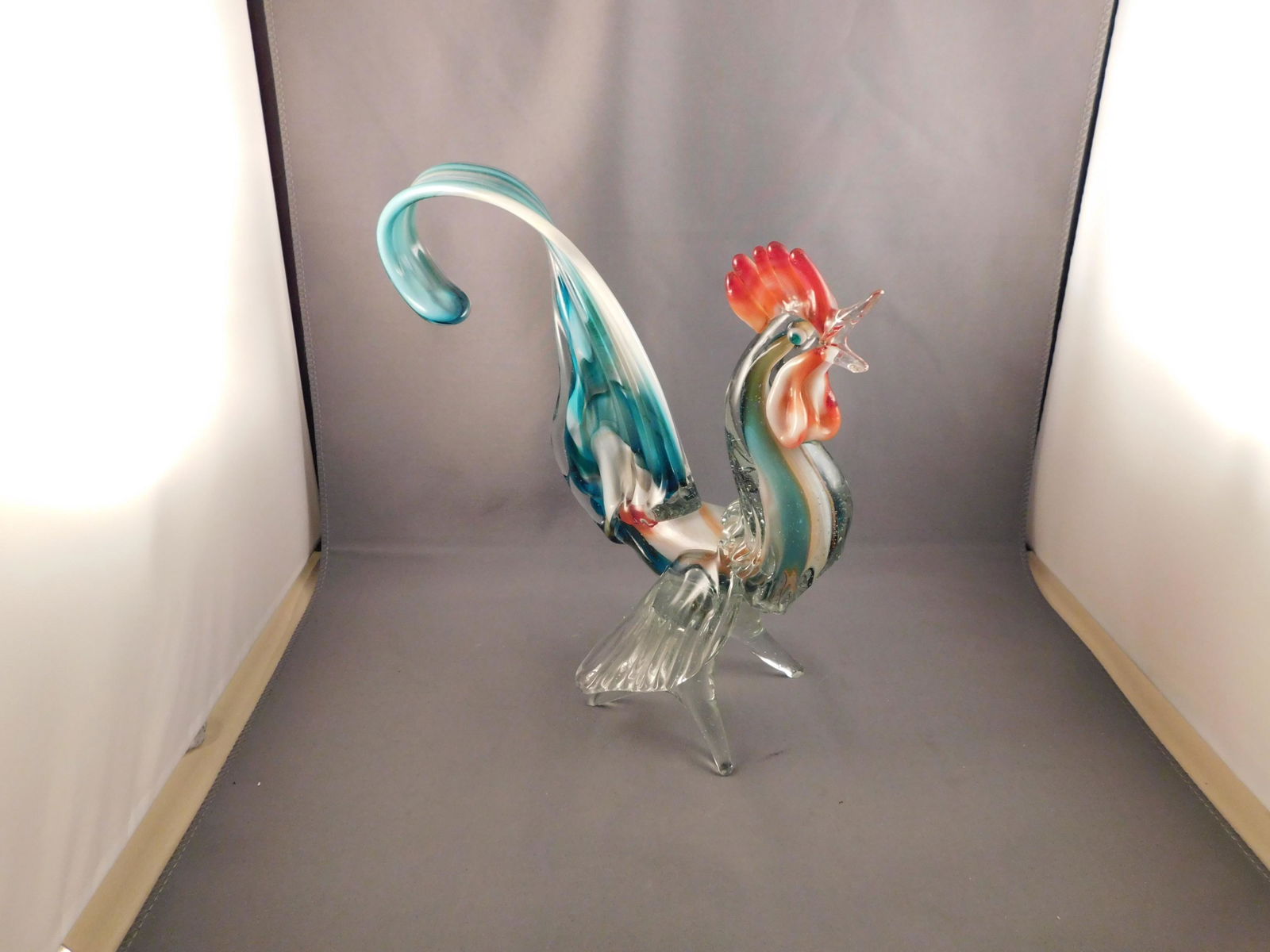 Art Glass Rooster: Art glass rooster, Murano glass. Measures approx. 8 3/4" tall x 8" wide. You are bidding at a live sale. Please read the terms and conditions. We are offering no contact pick up at our South Brunswick